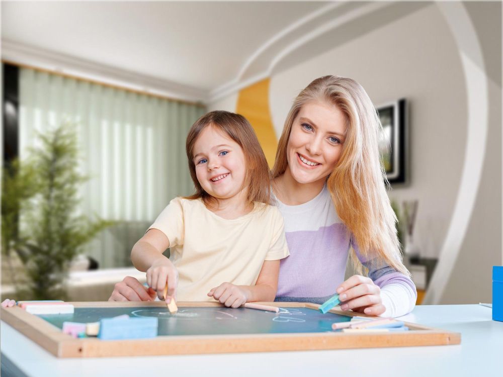 Therapist and a child playing with a chalkboard