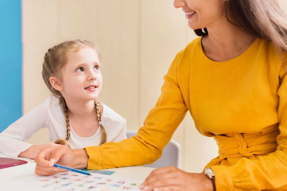 Empire ABA therapist smiling with a child
