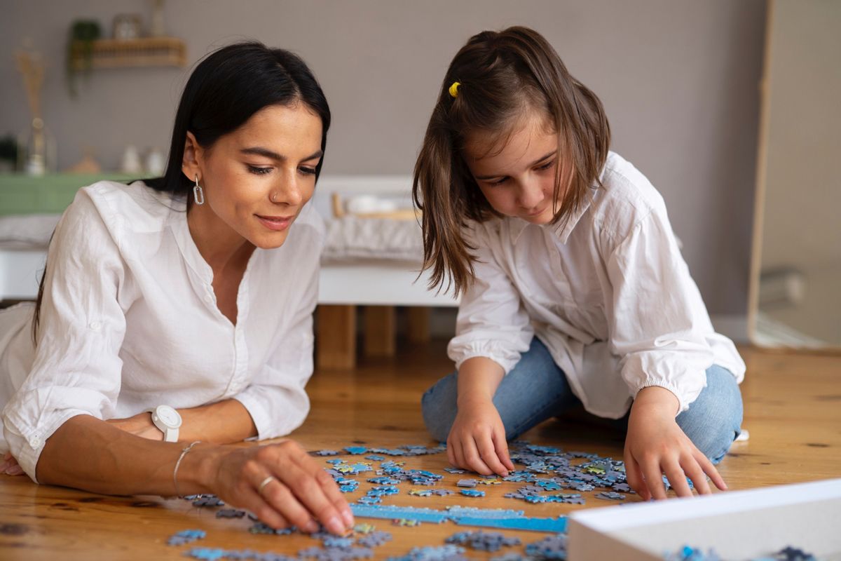 RBT and child working on a puzzle together